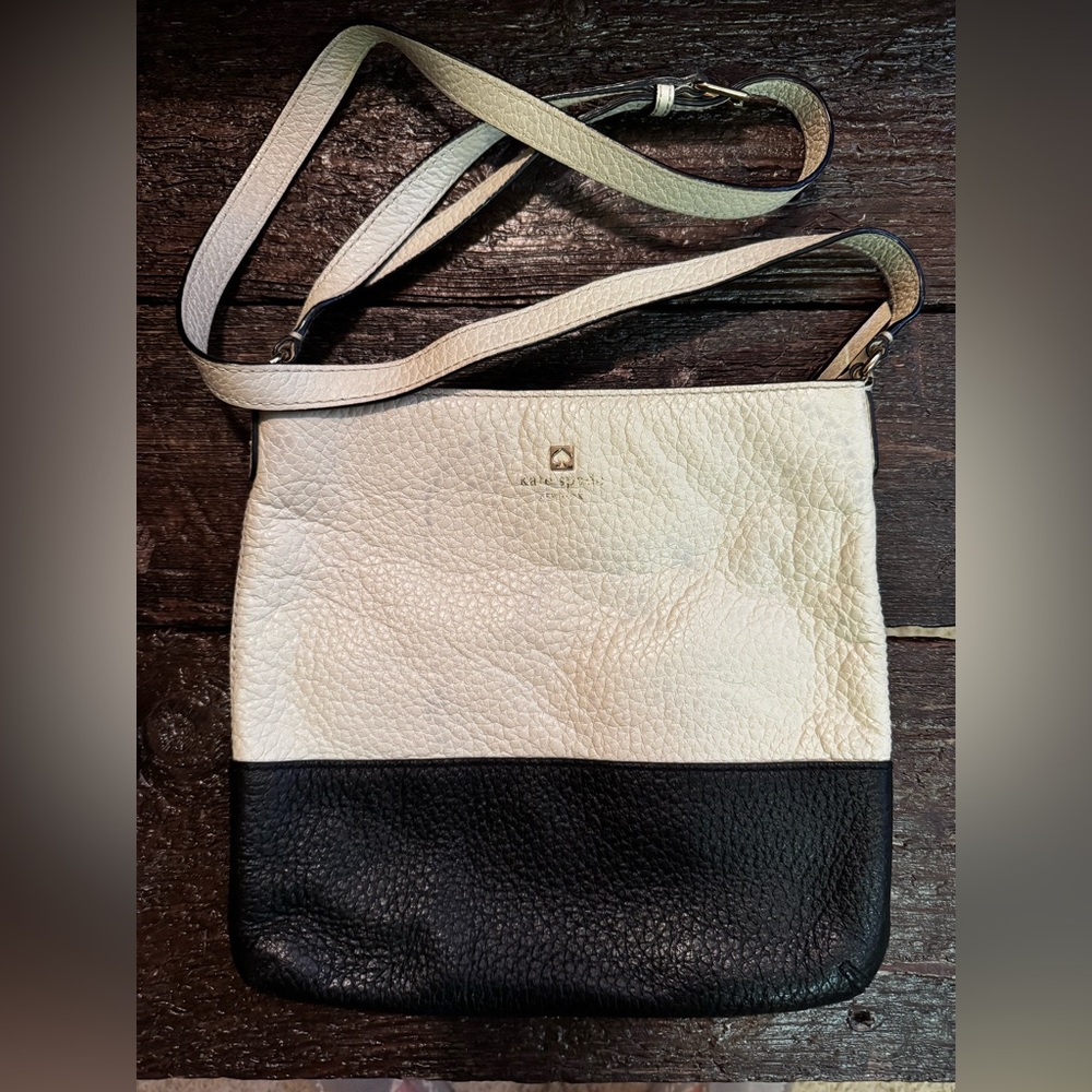 Kate Spade crossbody bag—cream/black with black/white striped interior.